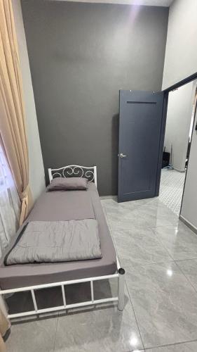 a bed sitting in a room with a door at The Fath Homestay Pasir Mas Tanah Merah Rantau Panjang in Pasir Mas