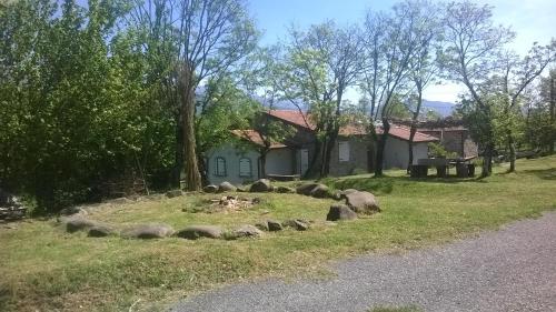 a herd of sheep in the grass next to a house at Locanda di Campagna in Mulazzo