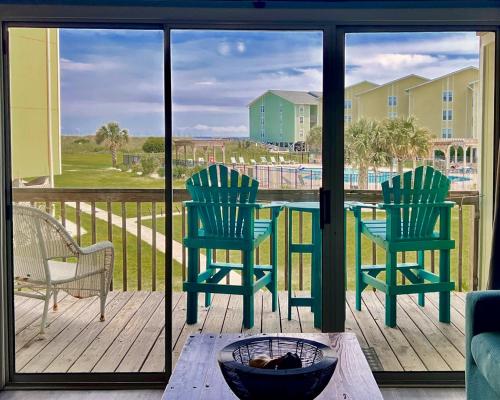 two chairs and a table on a porch with a view at Oceanview Surf Condo 517 with Pool Beach Access in Surf City