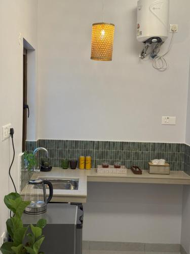 a kitchen with a sink and a counter top at Casa Susegado in Taleigao