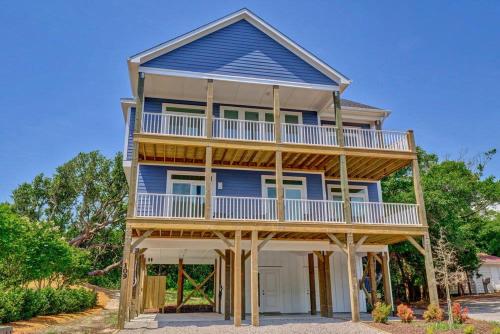 a large blue house with a large balcony at Good Vibes - Ocean View Home With Elevator in Surf City