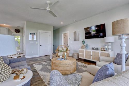 a living room with a couch and a table at Good Vibes - Ocean View Home With Elevator in Surf City