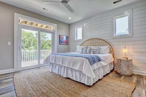 a bedroom with a bed and a large window at Good Vibes - Ocean View Home With Elevator in Surf City