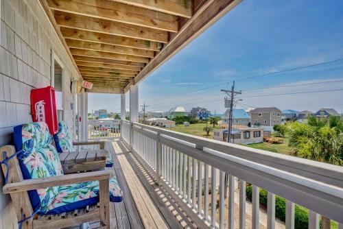 a porch with a bench and a view of the ocean at Oceanview Condo - Sea Coast Suites 18 in Surf City, NC in Surf City