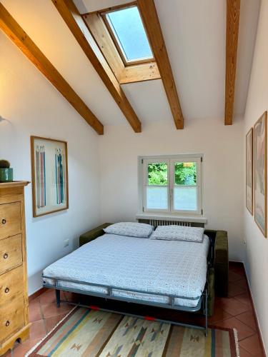 a bedroom with a bed and two windows at Laghel7 Agritur in Arco