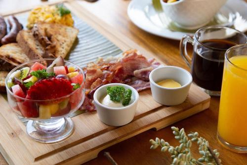 a table with a tray of breakfast foods and drinks at Villas Roma Del Mar in Playa Naranjo
