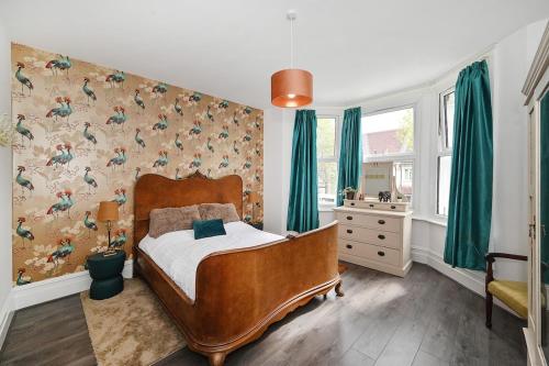 a bedroom with a bed and green curtains at South Croydon, garden maisonette, free parking, Gatwick accessible in Purley