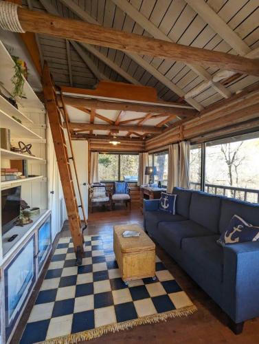 a living room with a blue couch and a checkered floor at Lake Lucerne 9 -Nauti or Nice in Eureka Springs
