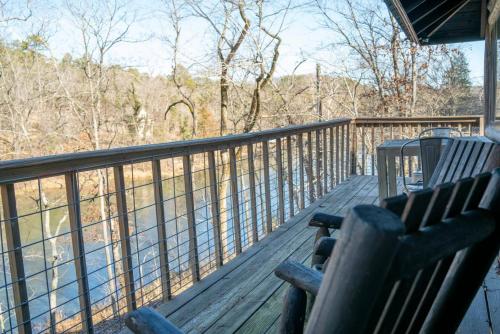 a porch with two wooden benches on a balcony at Lake Lucerne 9 -Nauti or Nice in Eureka Springs