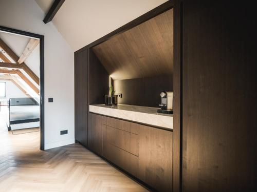a kitchen with wood cabinets and a counter top at Suite Ouddorp - 2 pers in Ouddorp