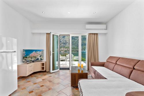a living room with a couch and a television at Apartments Dončić in Kotor
