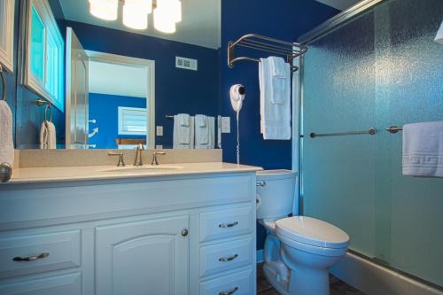 a blue bathroom with a sink and a toilet at F-15 Haunted Mansion in Anaheim
