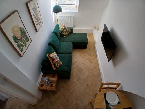 an overhead view of a living room with a green couch at Seashell Apartment in Barmouth