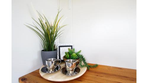 a tray with three cups on a table with plants at Malniri Park by Tiny Away in Wilberforce
