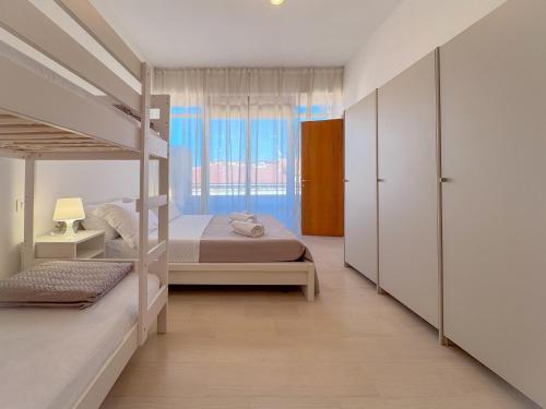 a bedroom with two bunk beds and a window at Vittorio Veneto - Spacious and Bright by Host Hero in Civitanova Marche