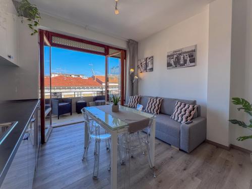 a kitchen and living room with a table and a couch at Vittorio Veneto - Spacious and Bright by Host Hero in Civitanova Marche