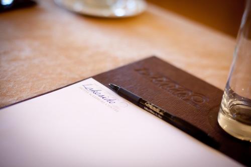 a pen sitting on top of a paper on a table at The Lakeside Hotel & Leisure Centre in Killaloe
