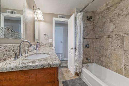 a bathroom with a sink and a tub and a shower at F-66 Poolside Retreat in Anaheim