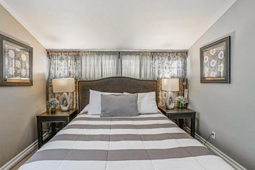 a bedroom with a large bed with two night stands at F-66 Poolside Retreat in Anaheim
