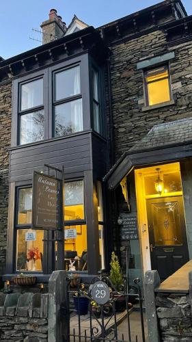 a restaurant with a sign in front of a building at Autumn Leaves Guest House in Windermere