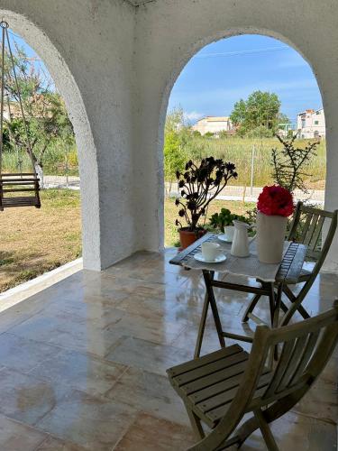 a patio with a table and chairs and a view at Cielo Mar in Mólos