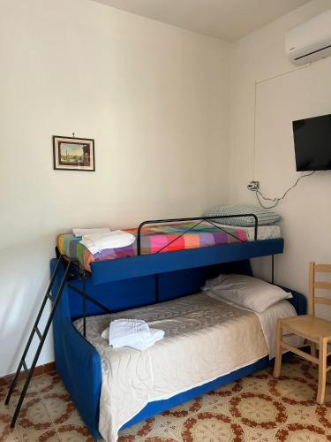 two bunk beds in a room with a television at Atomos in Alvignano