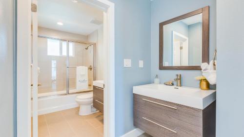 a bathroom with a sink and a toilet and a mirror at F-52 Trenton II in Anaheim