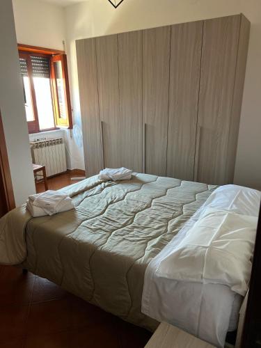 a bedroom with a large bed with white sheets at Atomos in Alvignano