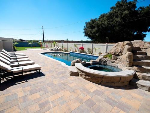 a patio with a pool and a bench next to at F-33 Walts Place in Anaheim