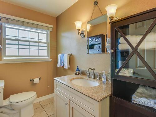 a bathroom with a sink and a toilet and a window at F-29 The Pirates Cove in Anaheim