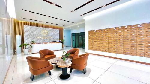 a lobby with chairs and a table in a building at Luxury Apartment Charm City in Dĩ An