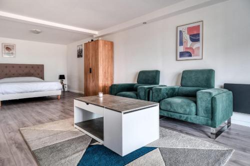 - un salon avec 2 fauteuils verts et un canapé dans l'établissement Maison Zen 2, à Équemauville