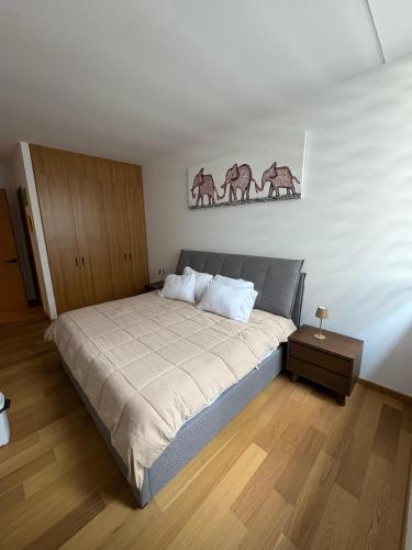 a bedroom with a large bed with two paintings on the wall at Londres #187 in Mexico City