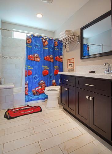 a bathroom with a race car shower curtain at F-16 Pirates Lair in Anaheim