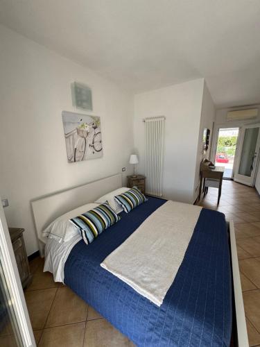 a bedroom with a large bed with blue sheets and pillows at Affittacamere PZ in Vernazza