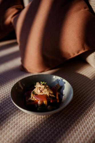a person sitting with a plate of food on a table at Agriturismo Zapparè Farm Hotel in Trevignano