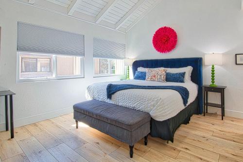 a bedroom with a bed with a red pompom on the wall at New Suite Escapes 5 by Funtierland Vacation Rentals in Anaheim