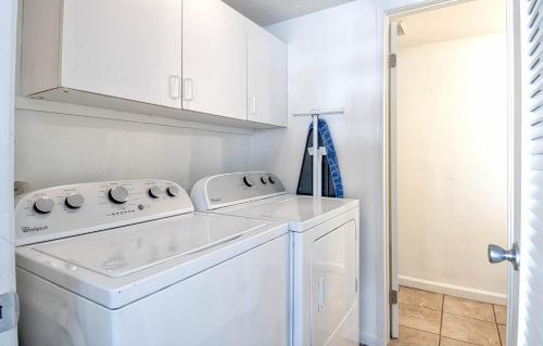 a white washer and dryer in a laundry room at Tron by Funtierland Vacation Rentals in Anaheim