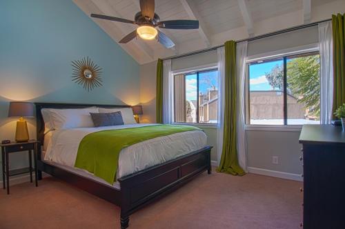 a bedroom with a bed and a ceiling fan at Love Bug by Funtierland Vacation Rentals in Anaheim