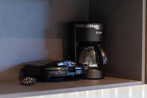 a coffee maker sitting on top of a counter at TOLIVE One Housi Recife by Carpediem in Recife
