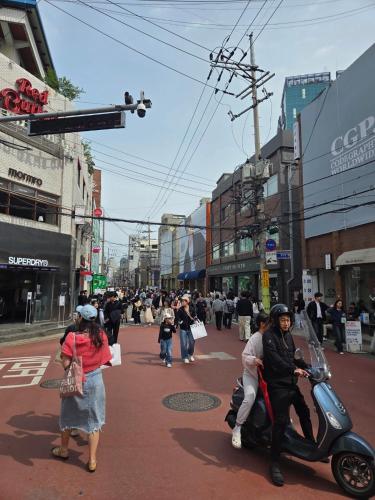 a group of people riding a scooter on a city street at Forest Hangang in Seoul