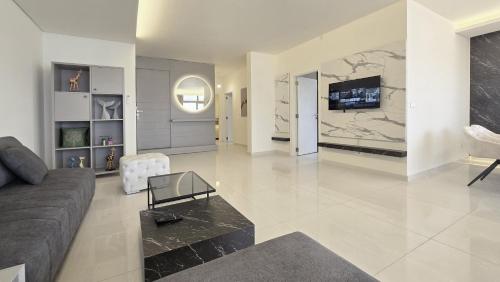 a living room with a couch and a tv at Tabarja Hills apartment in ‘Ayn aş Şughayrah