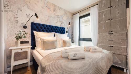 a bedroom with a bed with two pillows on it at Flatbook - City Center Apartment Bank Polsk in Gdynia