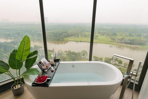 a bath tub in a bathroom with a view of a river at -20 Off I Beloving Home I 3BR Lakeview I Onsen I Golf View in Cong Luận