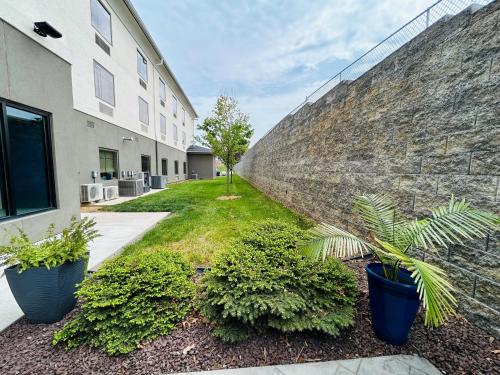 a retaining wall with plants in front of a building at Holiday Inn Express & Suites Shippensburg by IHG in Shippensburg