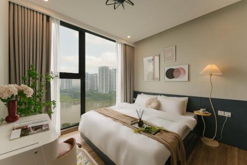 a bedroom with a large bed and a large window at -20 Off I Beloving Home I 3BR Lakeview I Onsen I Golf View in Cong Luận