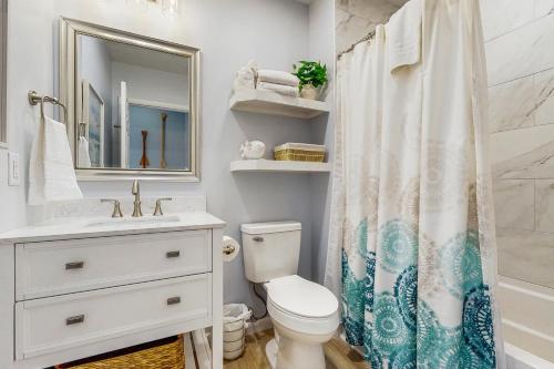 a bathroom with a sink toilet and a shower curtain at Sea Colony - 17001 Bayberry in Bethany Beach