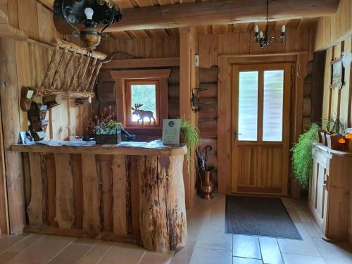 a log cabin kitchen with a large island in the center at La Fuste des Garceaux in Orconte