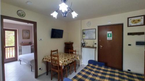 a bedroom with a table and a bed and a room at Casa Stella Baita Valle Viva in Roure Turin