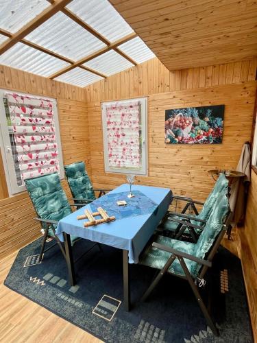 a dining room with a table and two chairs at Bungalowdorf Briesensee in Neu Zauche